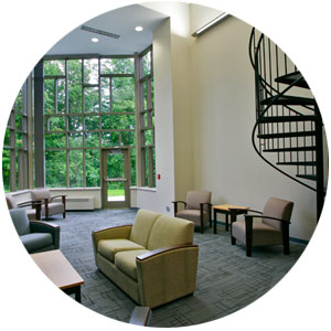 Academic lounge with wall of windows and spiral staircase